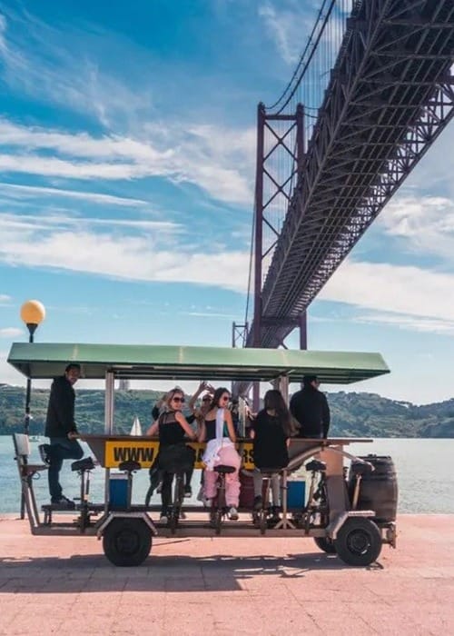 4. (2) a group of people on a cart by a bridge in Portugal
