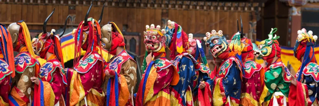 Bhutan dancers shutterstock 1277368810 1000x3000 1 scaled 1